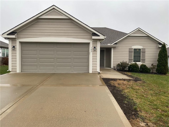 single story home featuring a front yard, roof with shingles, driveway, and an attached garage