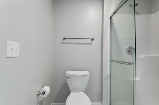 bathroom with toilet and a shower