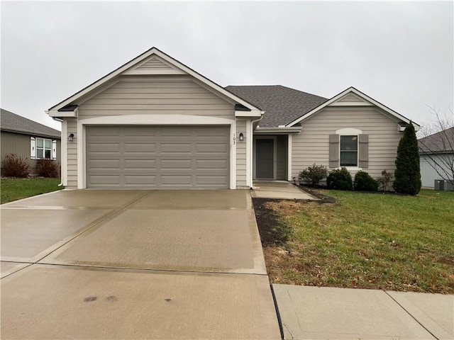 ranch-style house with driveway, a garage, central AC unit, roof with shingles, and a front yard