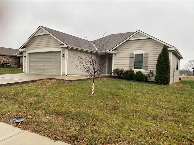 ranch-style house featuring an attached garage, a front lawn, concrete driveway, and roof with shingles