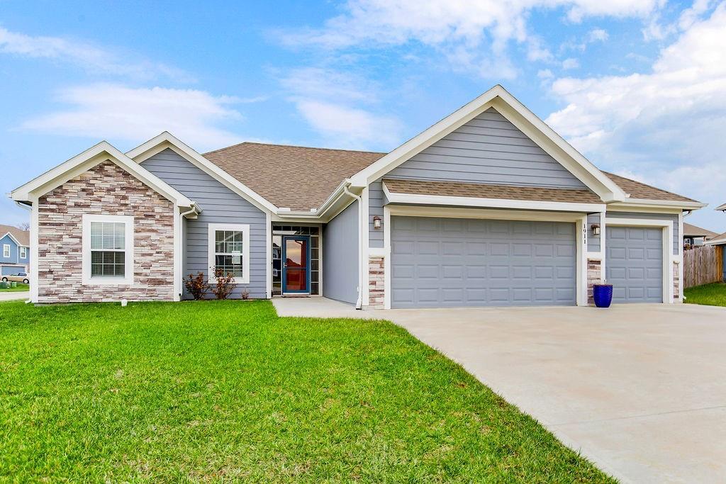 view of front of property with a garage and a front lawn