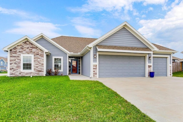 view of front of property with a garage and a front lawn