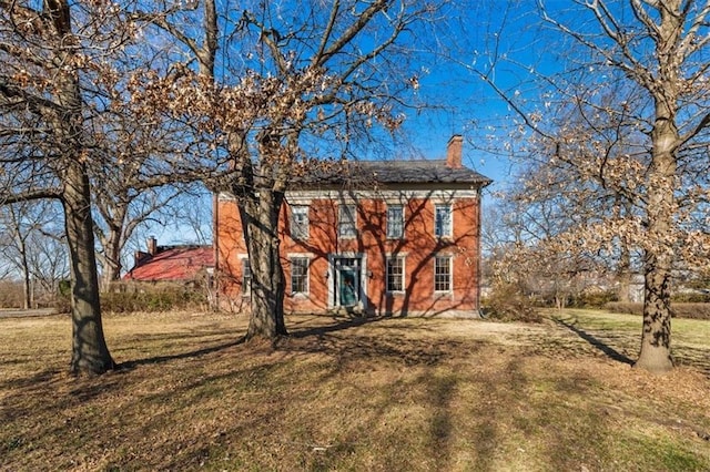 exterior space with a front yard and a chimney