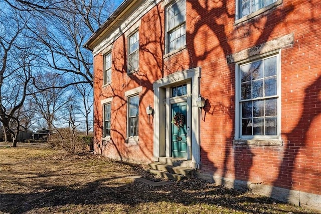 view of home's exterior with brick siding and entry steps