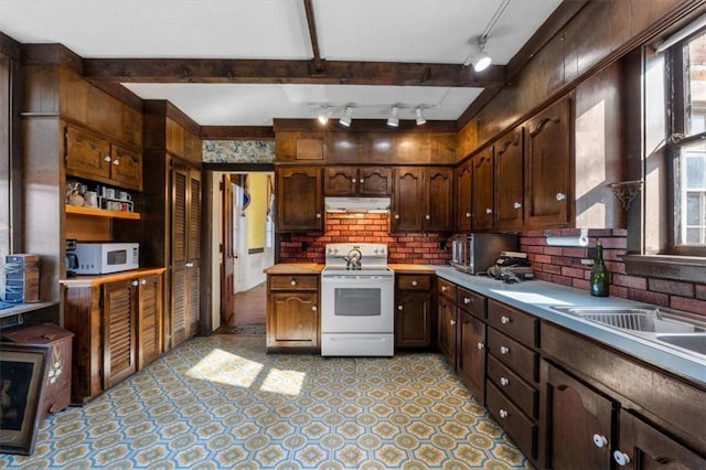 kitchen featuring under cabinet range hood, white appliances, dark brown cabinets, and light countertops