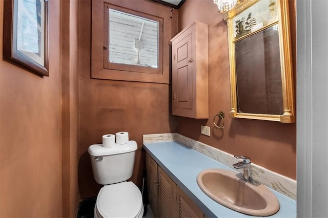 half bath featuring toilet and vanity