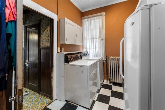 washroom featuring washer and clothes dryer, laundry area, light floors, and radiator heating unit