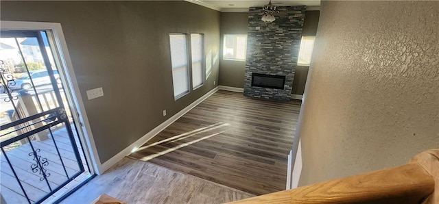 corridor with wood-type flooring and crown molding