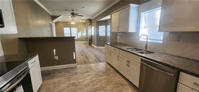 kitchen with tasteful backsplash, white cabinetry, dishwasher, and sink