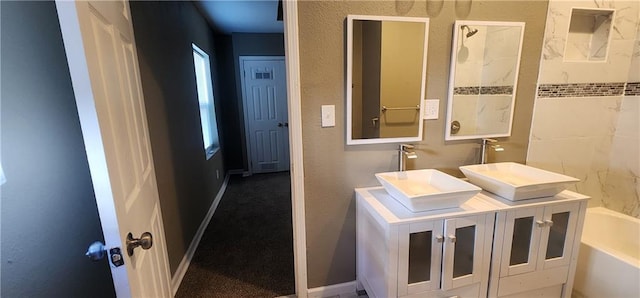 bathroom with a tub to relax in and vanity