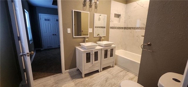 full bathroom with vanity, toilet, and tiled shower / bath combo