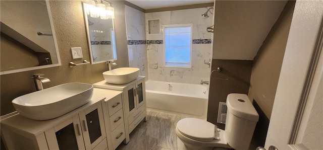 full bathroom with vanity, toilet, and tiled shower / bath combo