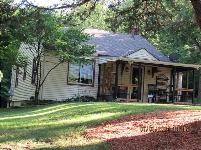 bungalow-style home featuring a porch and a front lawn