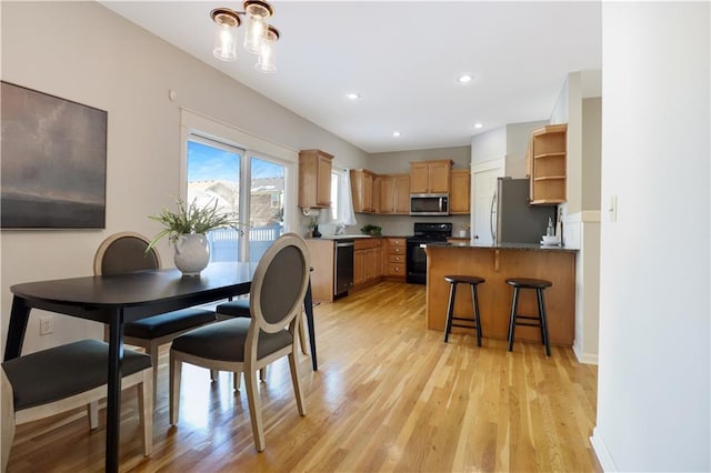 dining room with sink and light wood-type flooring