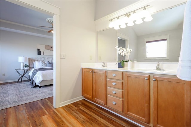 bathroom with wood-type flooring, vanity, and ceiling fan