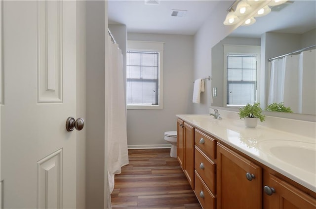 bathroom featuring toilet, vanity, and hardwood / wood-style flooring