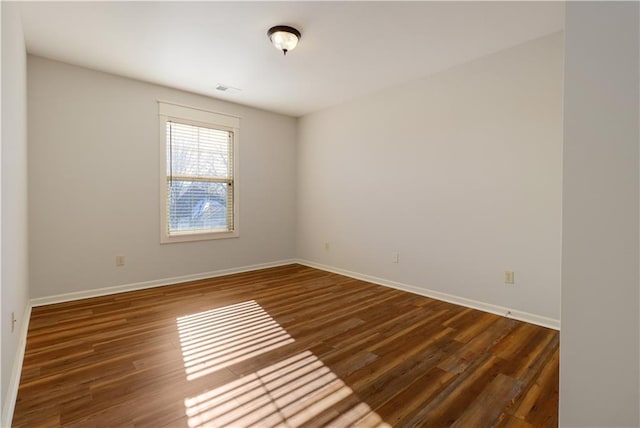 empty room featuring dark wood-type flooring