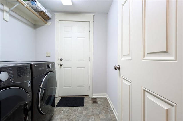 clothes washing area with separate washer and dryer