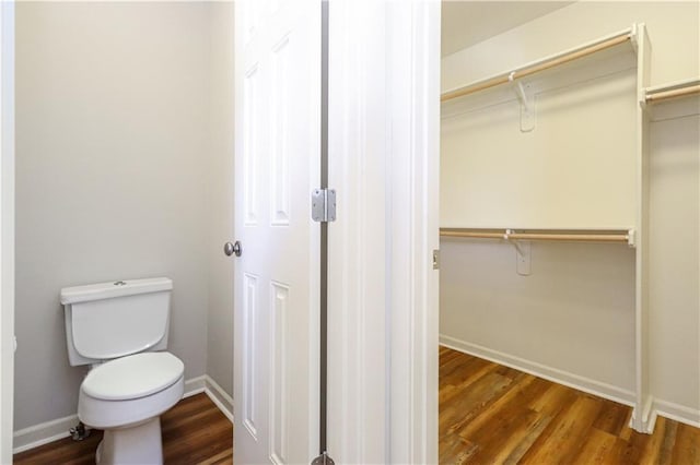 bathroom with toilet and wood-type flooring