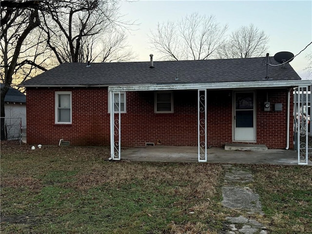 back of house with a yard and a patio