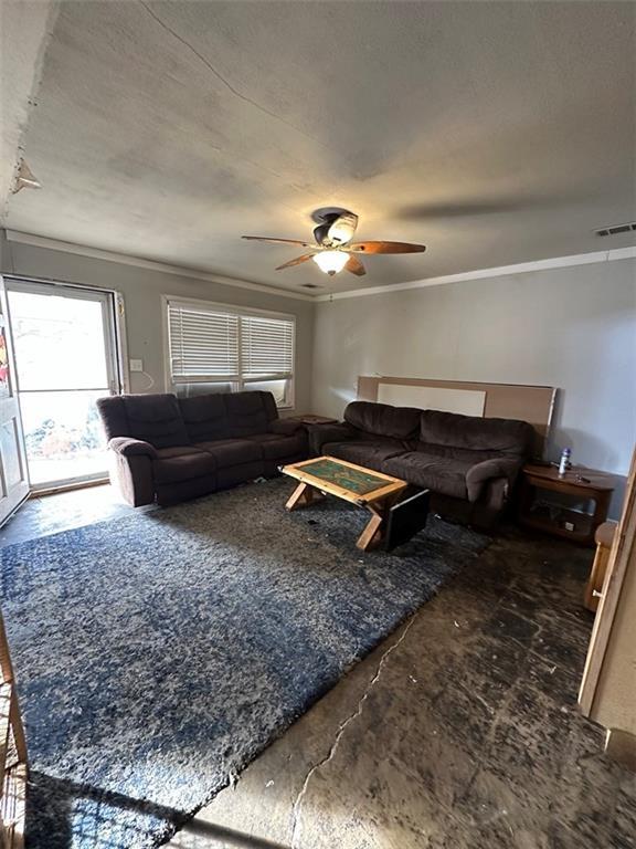 living room with crown molding and ceiling fan