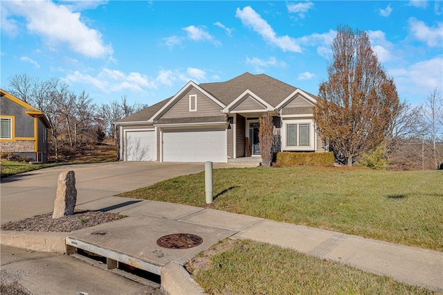 view of front of home with a front yard and a garage