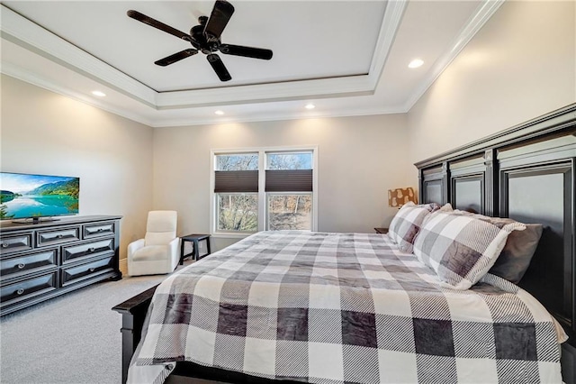 carpeted bedroom with ceiling fan, a raised ceiling, and crown molding