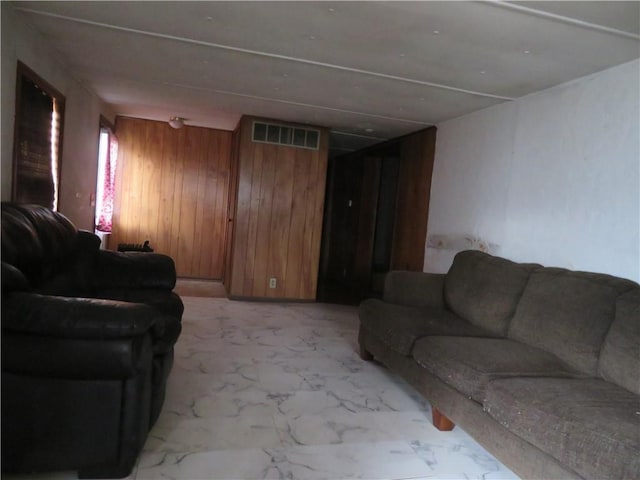 living room with wood walls