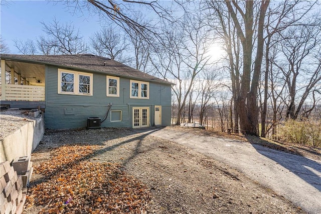 rear view of house featuring cooling unit and french doors