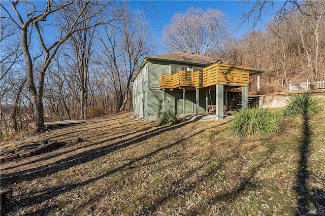 view of front of home with a deck and a front lawn