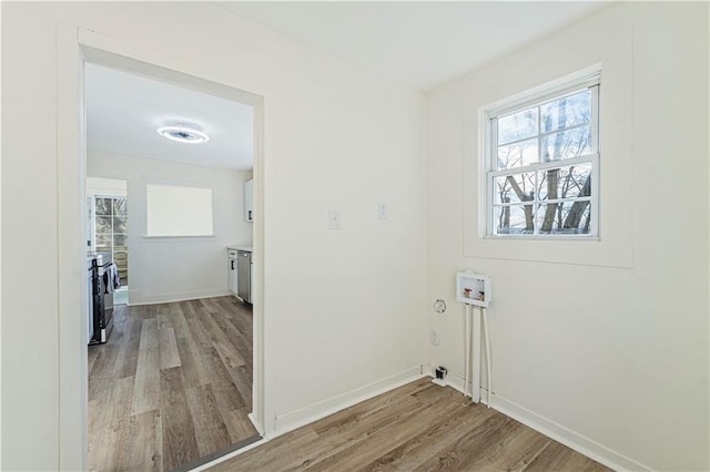 laundry room with washer hookup and light wood-type flooring