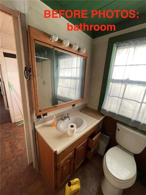 bathroom with tile patterned floors, vanity, and toilet