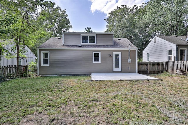 rear view of house with a patio area and a yard