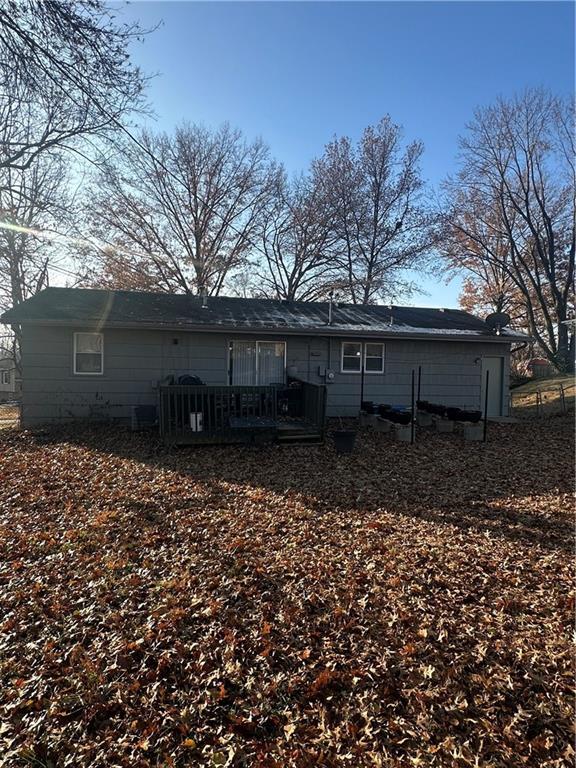 rear view of house featuring a wooden deck