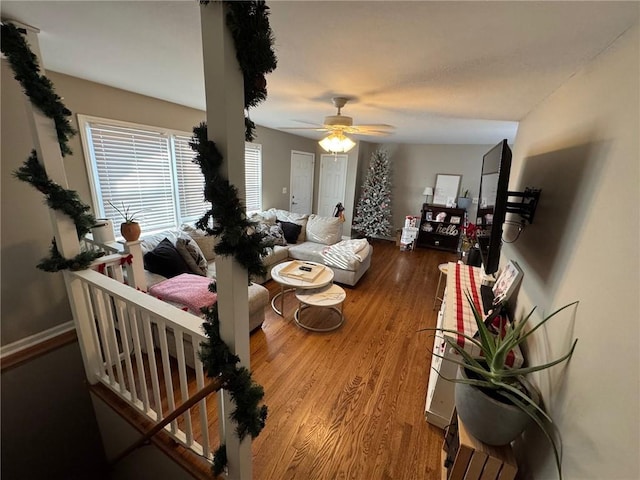 living room featuring ceiling fan and hardwood / wood-style floors