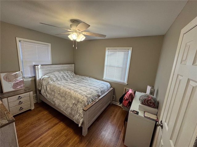 bedroom with dark wood-type flooring and ceiling fan