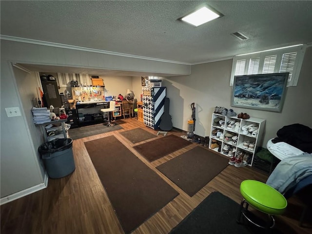 workout area featuring hardwood / wood-style flooring and a textured ceiling