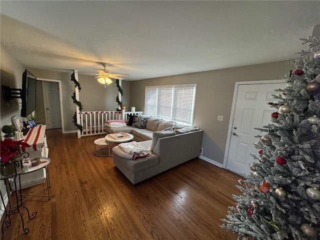 living room featuring ceiling fan and dark hardwood / wood-style flooring