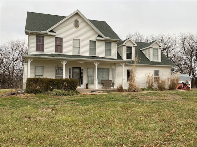 view of front of property featuring covered porch and a front yard