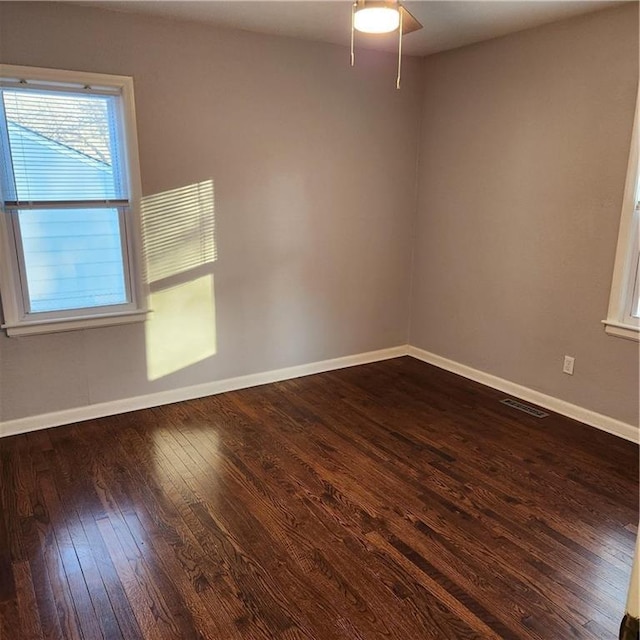 unfurnished room with dark hardwood / wood-style floors and ceiling fan