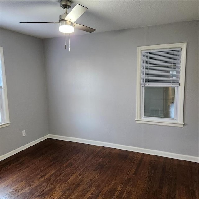 unfurnished room featuring ceiling fan and dark hardwood / wood-style floors