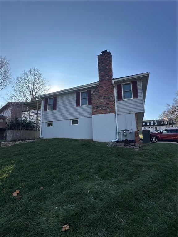 rear view of property featuring a lawn