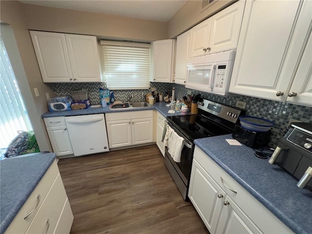 kitchen with dark wood-type flooring, sink, white cabinetry, tasteful backsplash, and white appliances