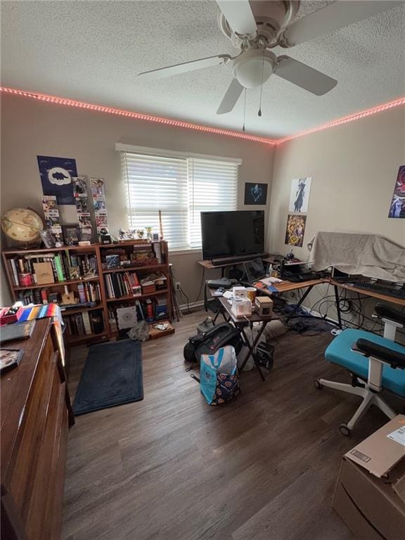 interior space featuring ceiling fan, dark hardwood / wood-style floors, and a textured ceiling