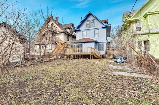 rear view of property featuring a wooden deck