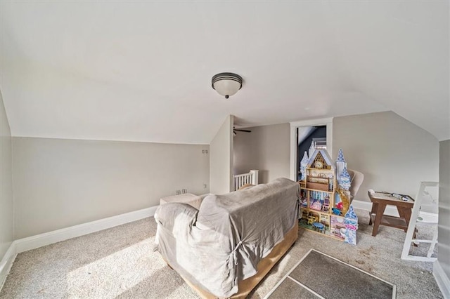 interior space with vaulted ceiling and carpet