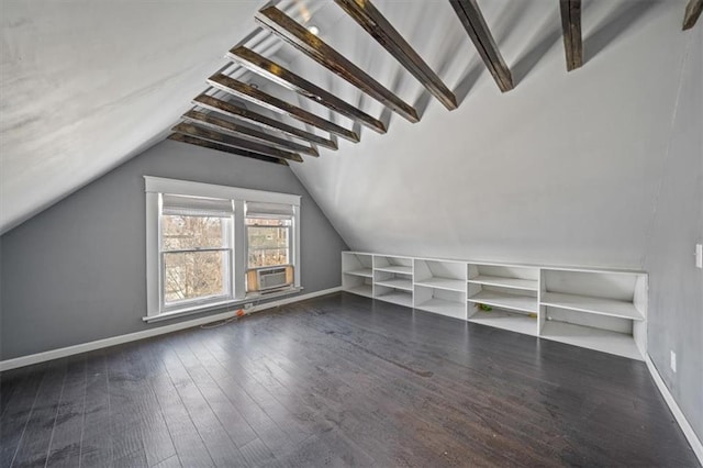 additional living space with cooling unit, dark wood-type flooring, and lofted ceiling with beams