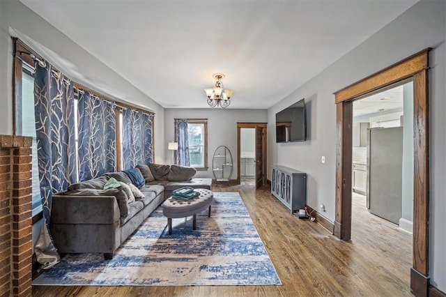 living room featuring wood-type flooring and a chandelier