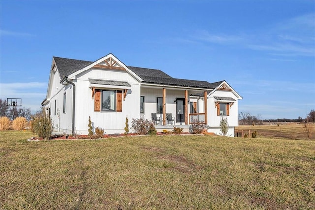 view of front of property with a porch and a front yard