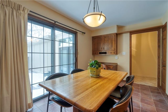 dining room with dark tile patterned flooring